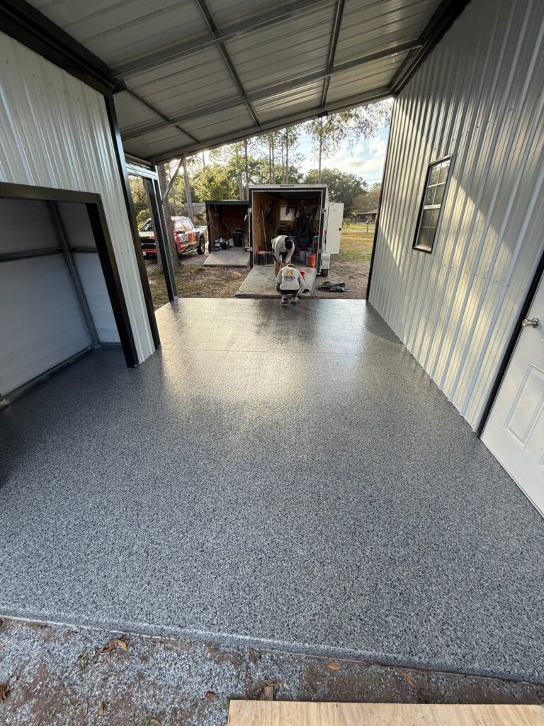 Freshly coated garage floor with durable, textured polyaspartic finish for enhanced durability and aesthetics.