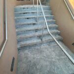 Concrete stairs with visible wear and dirt, leading to an upper level at Fruit Cove Baptist Church during Nightfall.