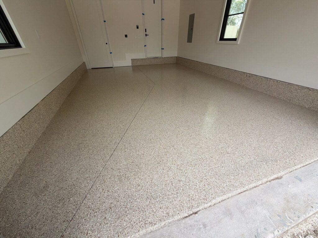 Clean, durable garage floor with a speckled finish in a residential space.