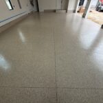 Polished polyaspartic garage floor with a smooth, glossy finish in a residential garage setting.